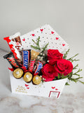 Sobre con rosas y chocolates