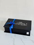 Caja Box personalizada con whisky black label, bombones, tarro de coctel de picoteo y vaso personalizado